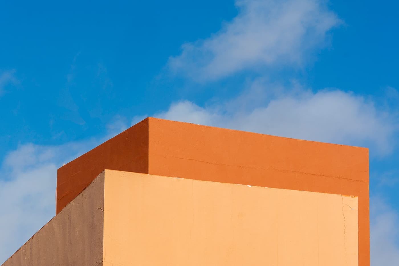 Color-block architecture beneath a blue sky